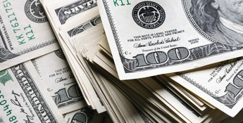Stacks of US hundred-dollar bills, reminiscent of farm financial gains, are arranged in a scattered manner.