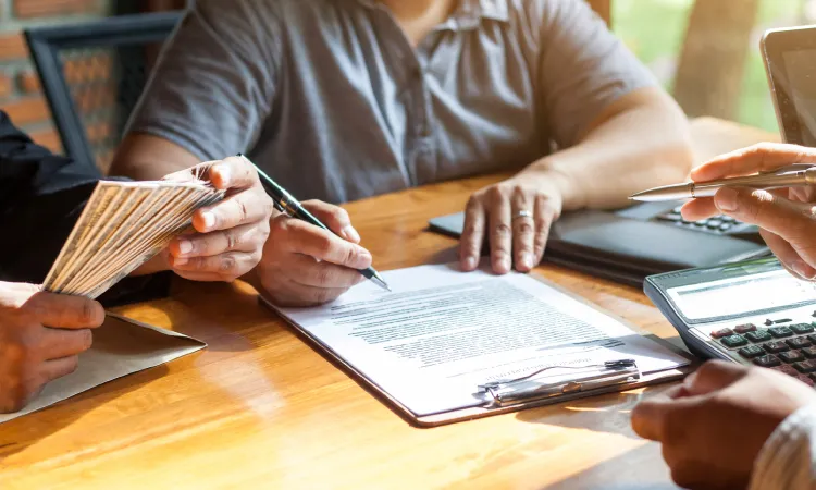 transactional advisory services while signing paperwork at a desk