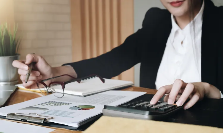 Accounting_woman_accountant_750x450 woman accountant at table with paperwork
