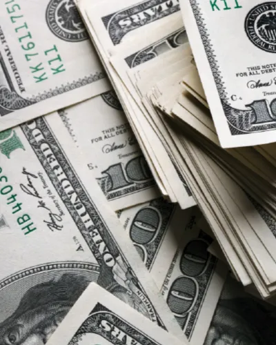 Stacks of U.S. hundred-dollar bills are piled together, showcasing various angles and views of the currency, much like the reserves held by financial institutions.