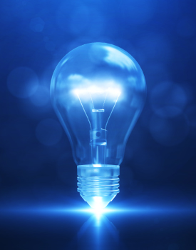 A glowing light bulb, symbolizing innovative HR services, floats with a bright blue glow against a blurred blue background, casting light from its base.
