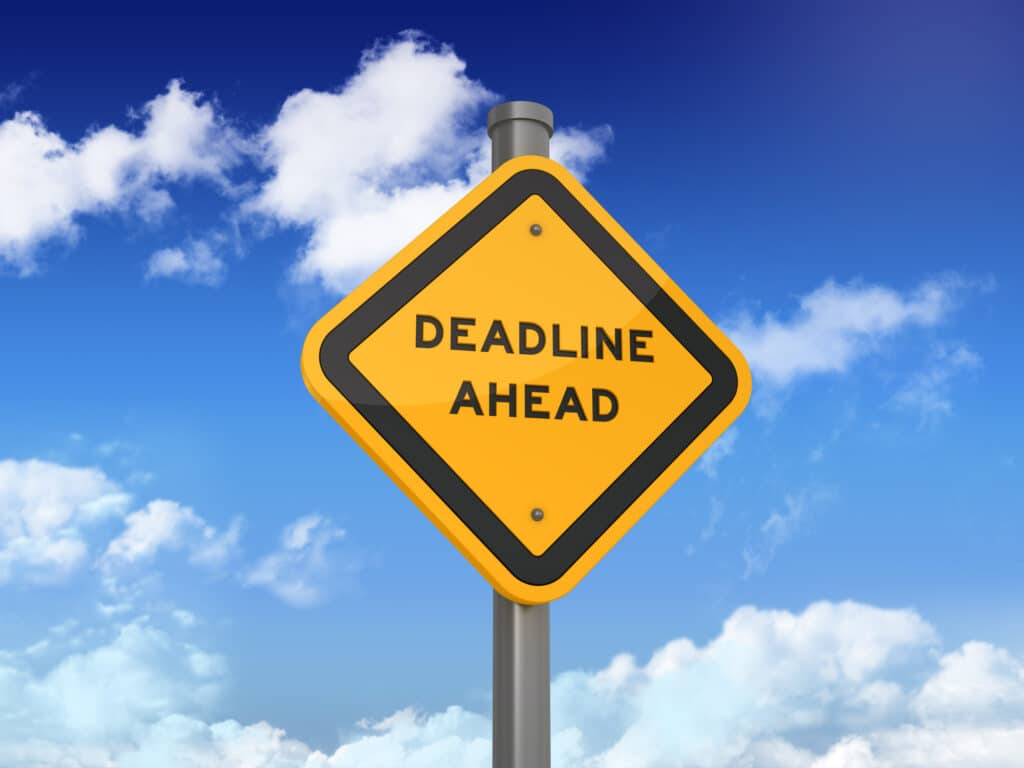 DEADLINE AHEAD Road Sign on Blue Sky and Clouds Background