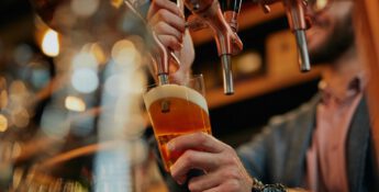 craft brewer pouring beer