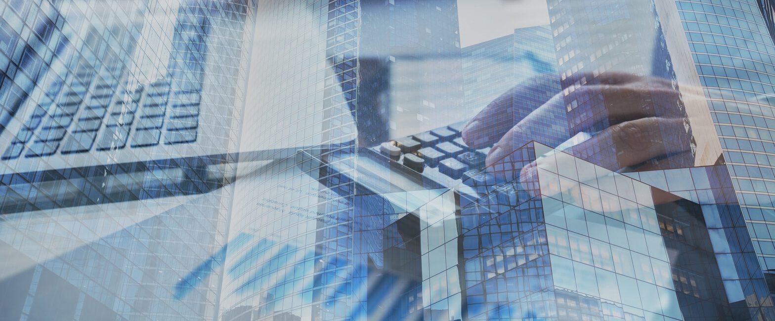 Hands typing on a keyboard are overlaid with images of modern office buildings and financial charts, subtly hinting at ASC 326 standards, which emphasize the integration of accounting with analytics.