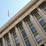 Facade of the United States Department of Agriculture building, featuring large columns and an American flag at the top, symbolizing its commitment to initiatives like ERP and PARP.