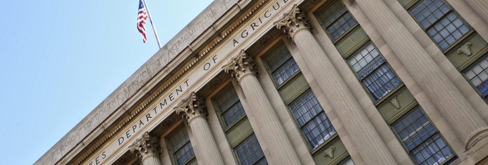 Facade of the United States Department of Agriculture building, featuring large columns and an American flag at the top, symbolizing its commitment to initiatives like ERP and PARP.