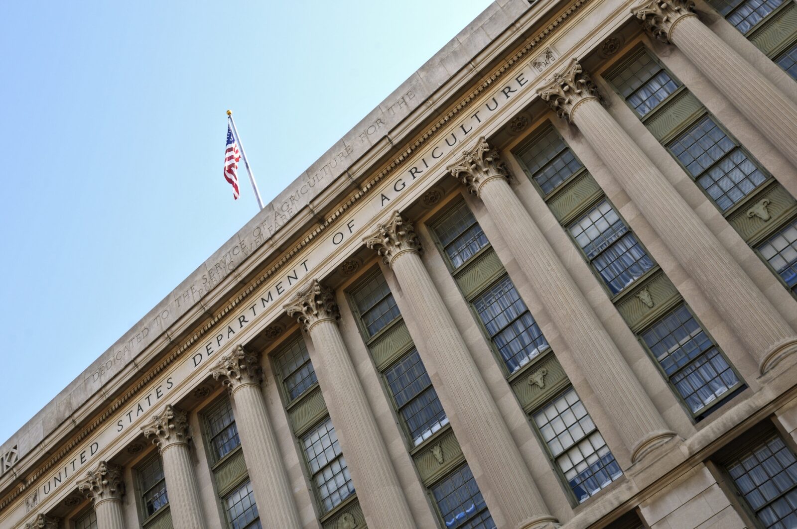 Facade of the United States Department of Agriculture building, featuring large columns and an American flag at the top, symbolizing its commitment to initiatives like ERP and PARP.