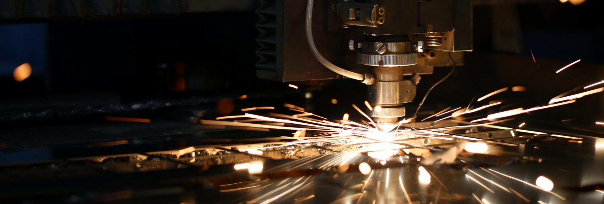 With sparks flying, the CNC machine efficiently cuts metal, showcasing advancements that highlight key 2025 tax changes impacting manufacturers.