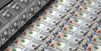 Printing press producing sheets of U.S. hundred-dollar bills.