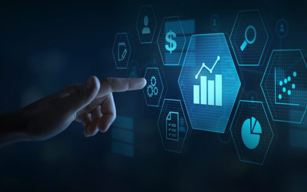 A hand points at a digital interface displaying data analytics icons, including charts, graphs, and financial symbols, on a dark blue background.