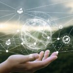 A hand is held up with digital icons and network lines floating above it, representing global connectivity, technology concepts, and the importance of Sustainability Data Management.