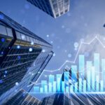Skyscrapers viewed from below with overlaid bar and line graphs representing financial growth and economic data trends.