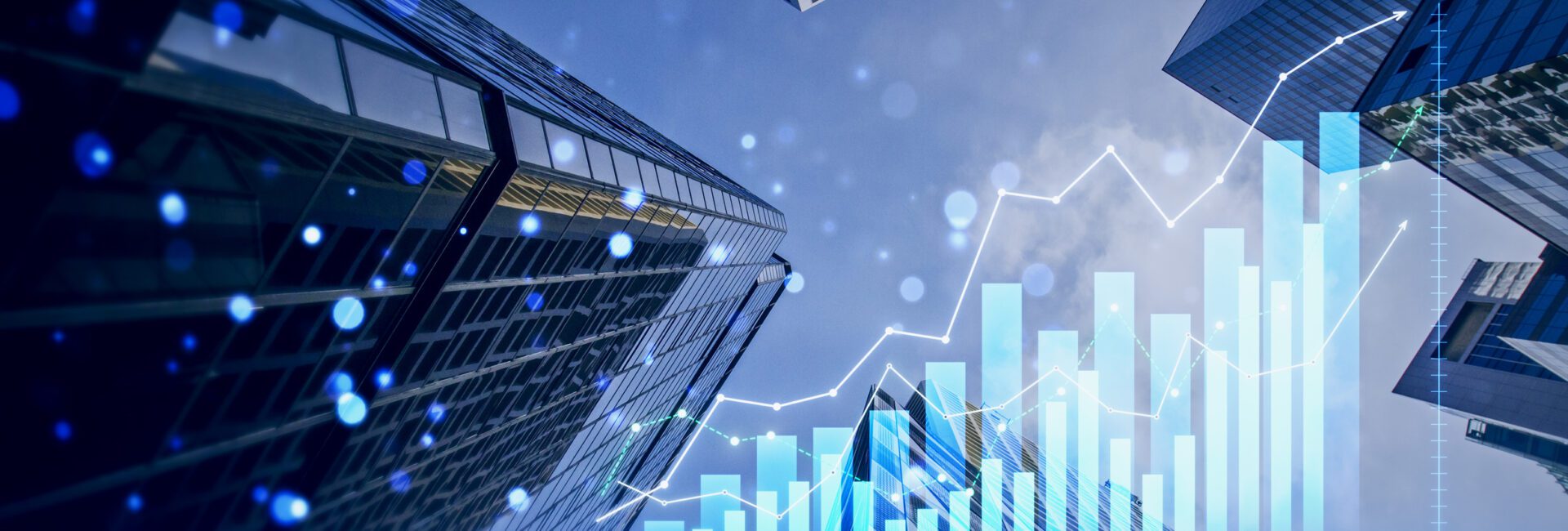Skyscrapers viewed from below with overlaid bar and line graphs representing financial growth and economic data trends.
