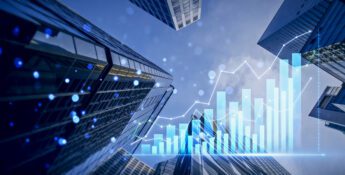 Skyscrapers viewed from below with overlaid bar and line graphs representing financial growth and economic data trends.