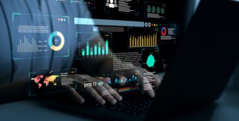 Person using a laptop with digital data dashboards, graphs, and charts projected above the keyboard, representing AI in Sustainability through advanced data analysis and business analytics.