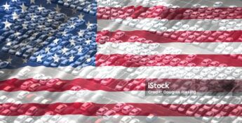 Rows of parked cars in a lot are overlaid with the image of the American flag, symbolizing the US automobile industry and highlighting the importance of Vehicle Loan Interest Reporting.