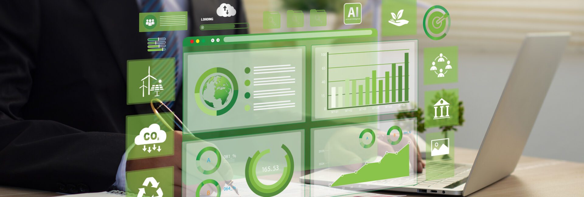 A person in a suit works on a laptop at a desk, using Fieldprint Platform Version 5, with virtual green sustainability and data charts displayed in front of them.