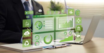 A person in a suit works on a laptop at a desk, using Fieldprint Platform Version 5, with virtual green sustainability and data charts displayed in front of them.
