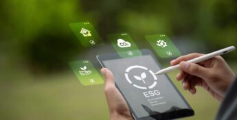 A person uses a stylus on a tablet displaying an ESG logo, with floating icons representing environmental, social, and governance concepts alongside sustainability data.