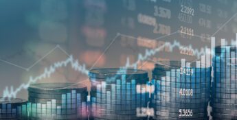 Stacks of coins arranged in ascending order with a transparent overlay of financial graphs and numbers in the background.