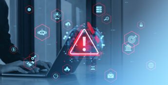 Person typing on a laptop with a large warning symbol on screen, surrounded by digital security and technology icons—highlighting what financial institutions must prioritize for 2026.