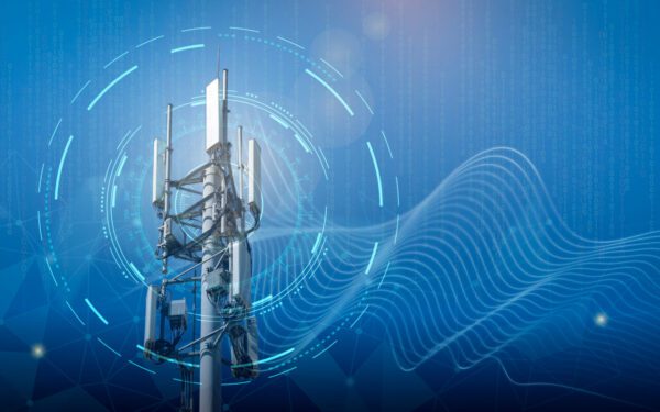 Cellular tower with antennas set against a digital blue background, featuring abstract lines and wave patterns representing wireless communication signals.