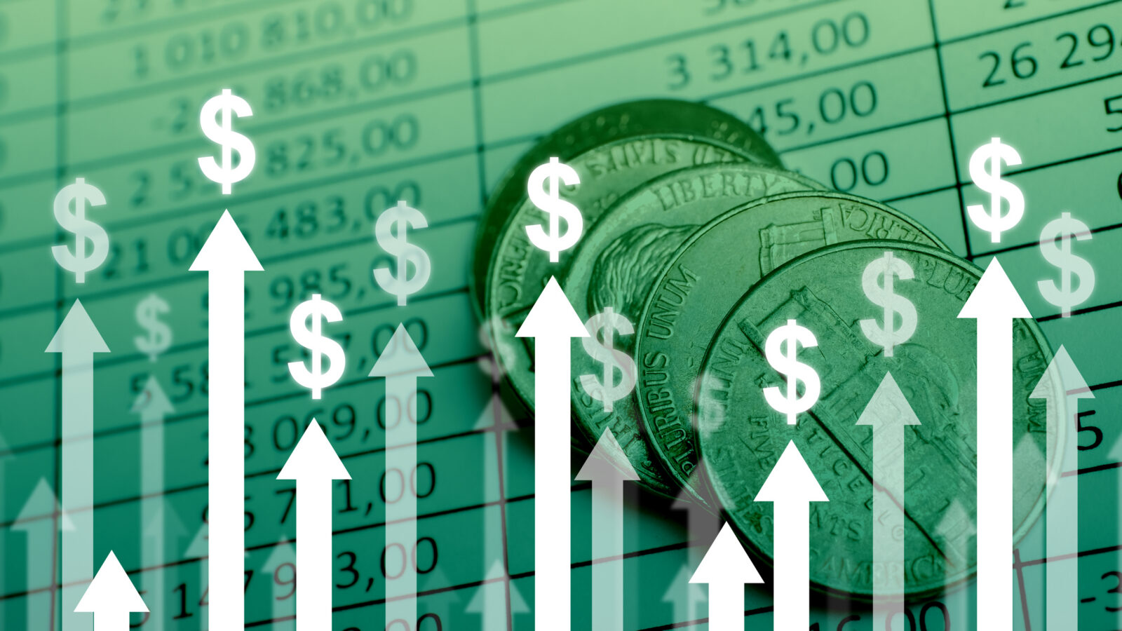 Coins on top of a financial spreadsheet with upward-pointing arrows and dollar signs, symbolizing financial growth or profit increase.