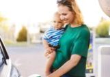 young-mother-with-baby-boy-at-the-petrol-station-picture-id870068620